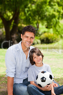 Father and his son with their ball in the park