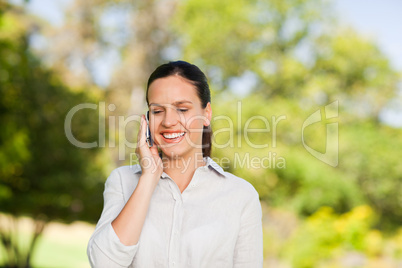 Young woman phoning in the park