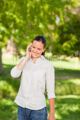 Young woman phoning in the park