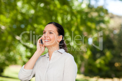 Young woman phoning in the park