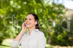 Young woman phoning in the park