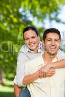 Man giving wife a piggyback