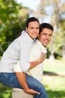 Man giving wife a piggyback