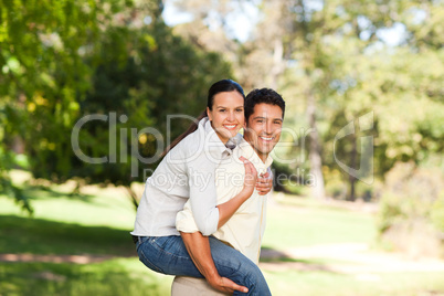 Man giving wife a piggyback