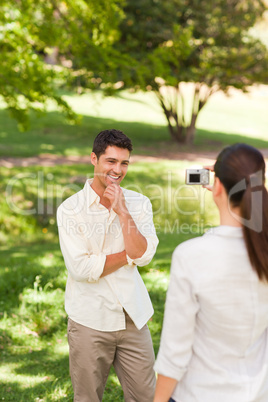 Woman taking a photo of her boyfriend