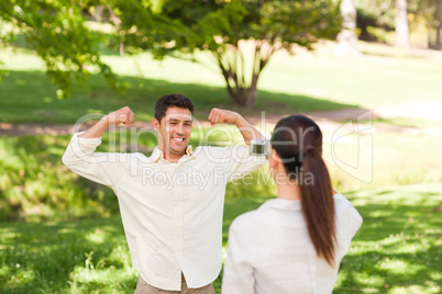 Woman taking a photo of her boyfriend