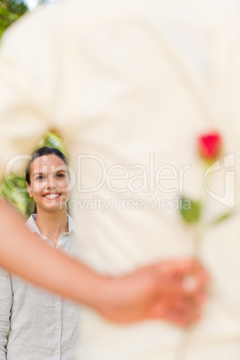 Happy man offering a rose to his girlfriend