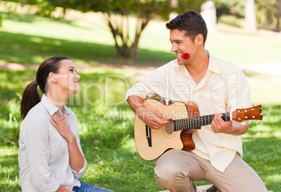 Man playing guitar for his girlfriend