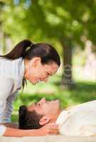 Happy couple lying down in the park