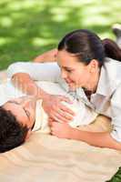 Happy couple lying down in the park