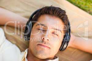 Young man listening to music in the park