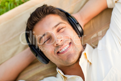 Young man listening to music in the park