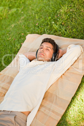 Young man listening to music in the park