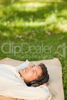 Young man listening to music in the park