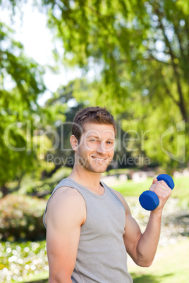 Young man doing his exercises in the park