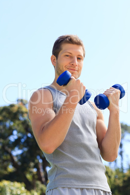 Young man doing his exercises in the park