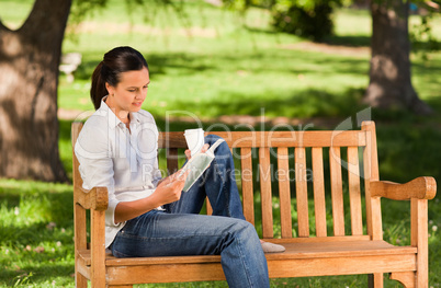 Young woman reading on the bench