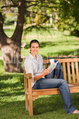 Young woman reading on the bench