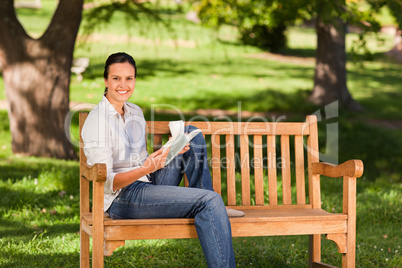 Young woman reading on the bench