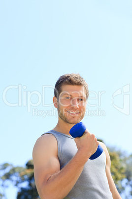 Young man doing his exercises in the park