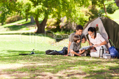 Joyful family camping in the park