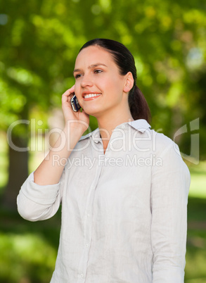 Woman phoning in the park