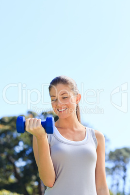 Young woman doing her exercises in the park