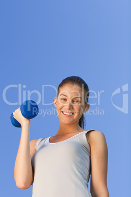 Young woman doing her exercises in the park