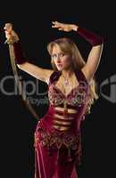 Beauty arabian dancer stand with saber on hip
