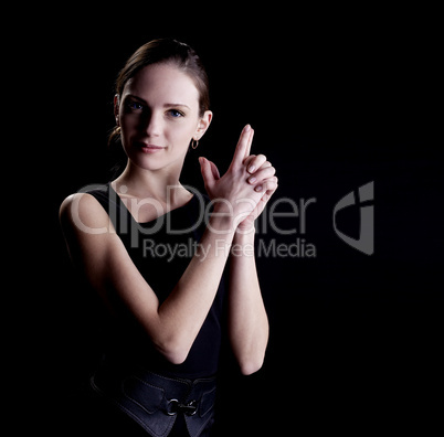 Young woman portrait with gun sign