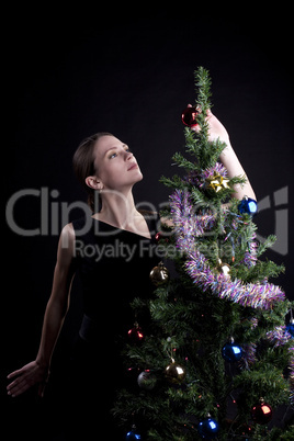 Young woman decorate christmas tree