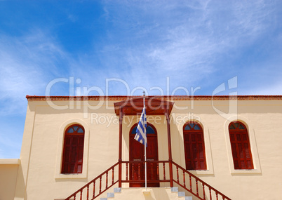 Old Greek religious building and flag, Crete, Greece