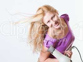 Portrait of a girl with a hairdryer