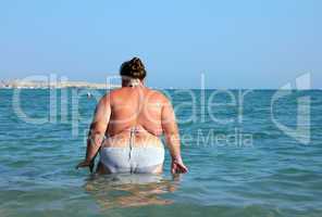 overweight woman bath in sea