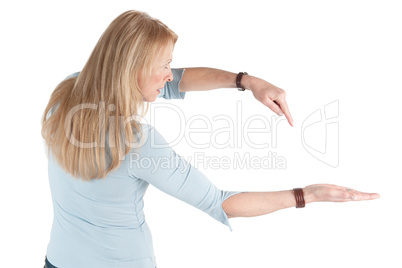 Middle aged woman pointing at her open hand