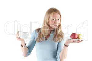 Middle aged woman with cup and fruits