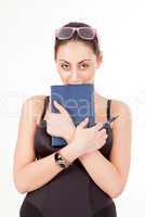 Pretty young girl with book, pen and glasses