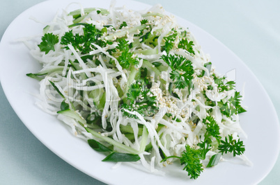 Salad of fresh cabbage and cucumber with herbs and sesame