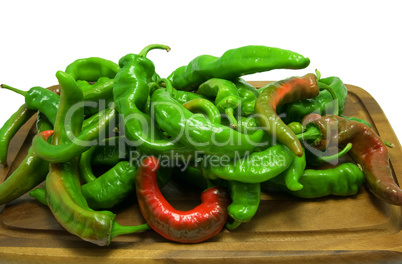Hot peppers on wooden kitchen board