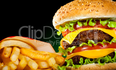 Tasty hamburger and french fries on a dark