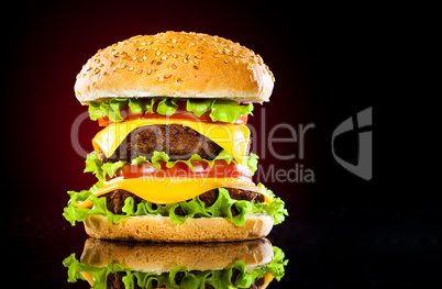 Tasty and appetizing hamburger on a darkly red