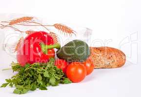 Pile of ripe vegetables and baguette in paper bag