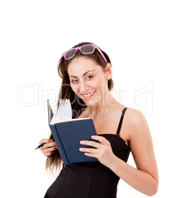 Pretty young girl in black corset with book, pen and glasses isolated on white