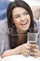 Hispanic Woman Laughing Drinking Glass of Water