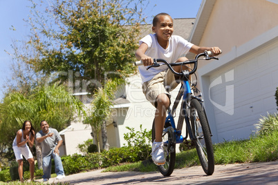 African American Family WIth Boy Riding Bike & Happy Parents