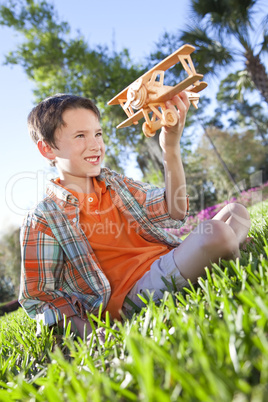 Young Boy Outside Playing With His Model Airplane