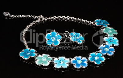 A blue necklace with flowers