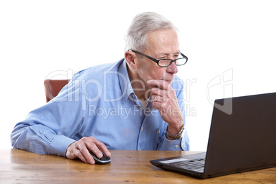 Senior man behind the computer