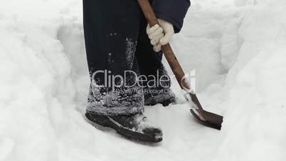 Man shoveling mass of snow