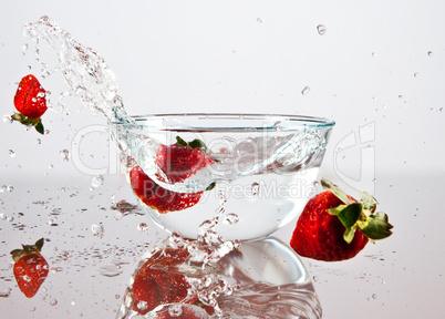 Strawberries falling into the water